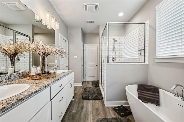 bathroom featuring decorative backsplash, vanity, plus walk in shower, and wood-type flooring