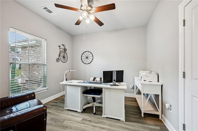 home office with ceiling fan and light hardwood / wood-style flooring