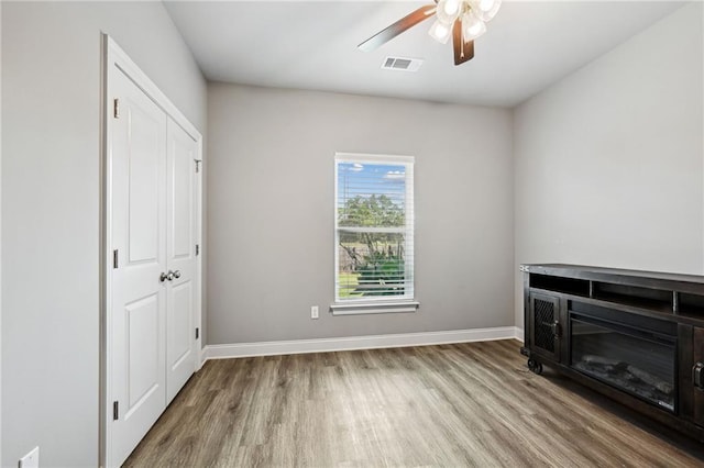 interior space featuring hardwood / wood-style floors and ceiling fan