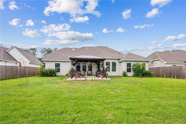 rear view of property with a patio, a yard, and a gazebo