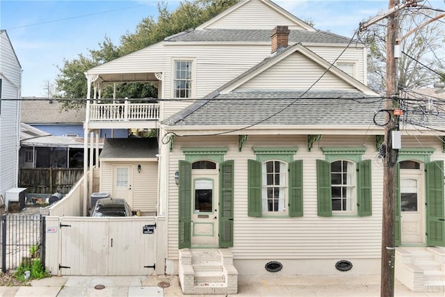 view of front of house with a balcony