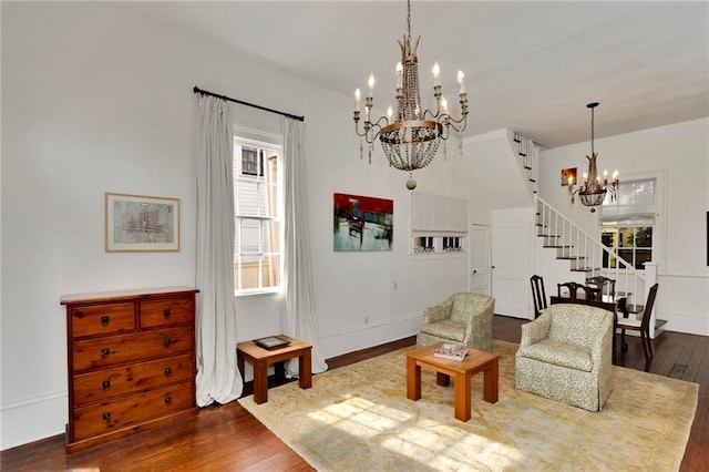 living room with wood-type flooring and an inviting chandelier