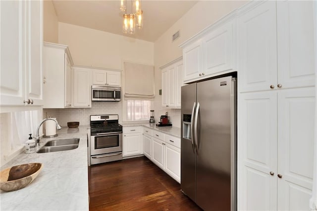 kitchen featuring sink, white cabinets, dark hardwood / wood-style floors, and appliances with stainless steel finishes