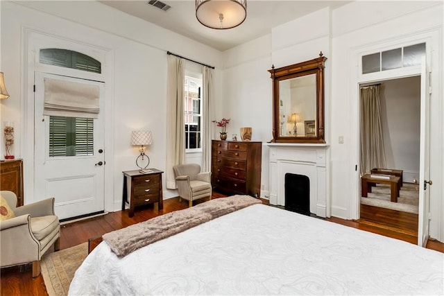 bedroom with dark wood-type flooring