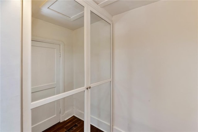 walk in closet with dark hardwood / wood-style flooring