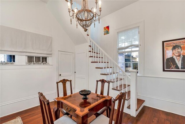 dining room with a high ceiling, dark hardwood / wood-style floors, and a notable chandelier