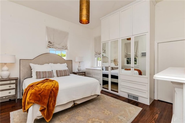 bedroom featuring a closet and dark wood-type flooring