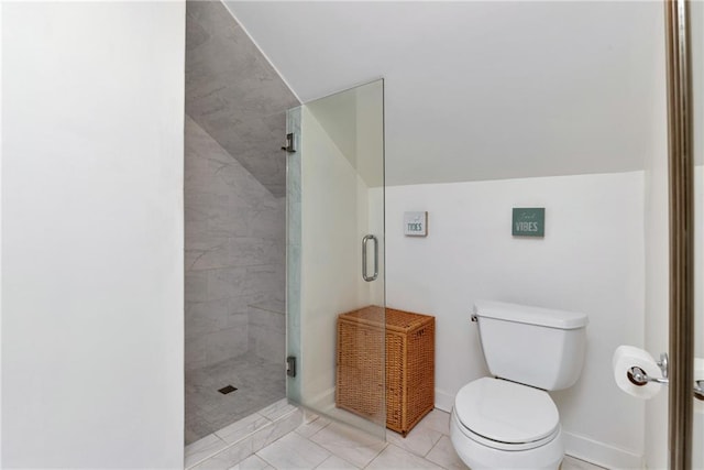 bathroom featuring tile patterned floors, toilet, and a shower with shower door