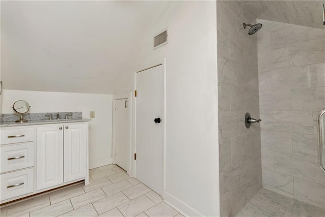 bathroom featuring vanity and a tile shower