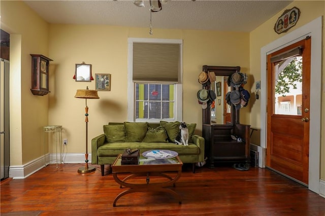 sitting room featuring a textured ceiling and dark hardwood / wood-style floors