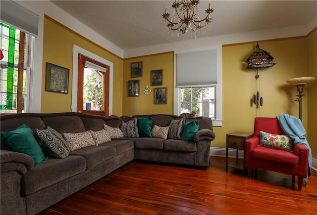 living room with hardwood / wood-style flooring, a chandelier, and a textured ceiling