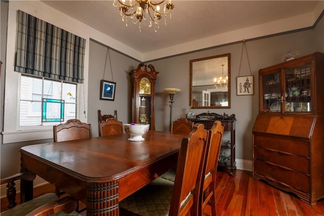 dining space featuring wood-type flooring and a chandelier