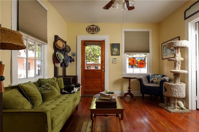 living room with ceiling fan and dark hardwood / wood-style floors