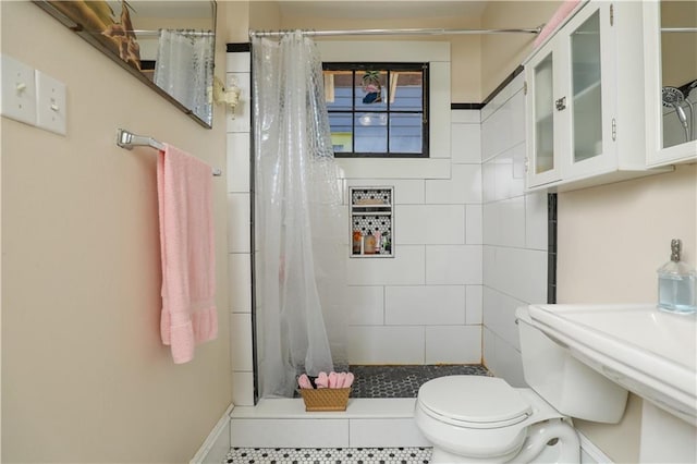 bathroom with toilet, a shower with shower curtain, and tile patterned flooring