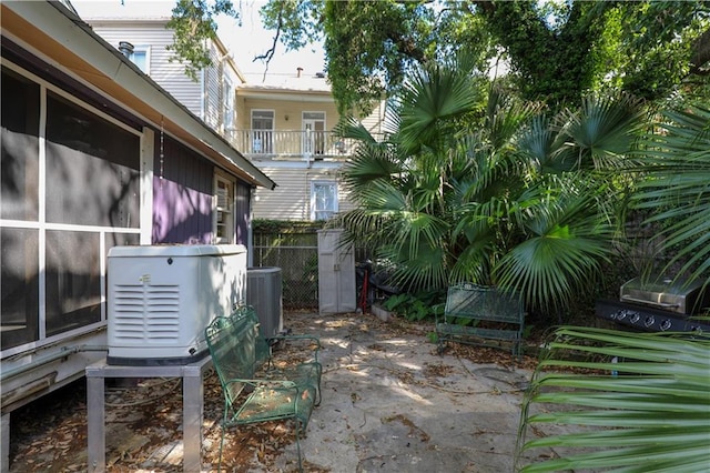 view of patio featuring a balcony and central air condition unit