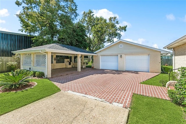 view of front of property featuring an outbuilding, a garage, and a front lawn