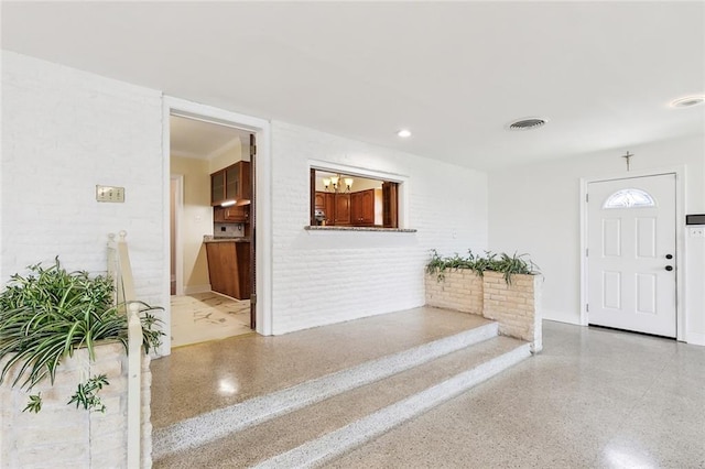 foyer with brick wall