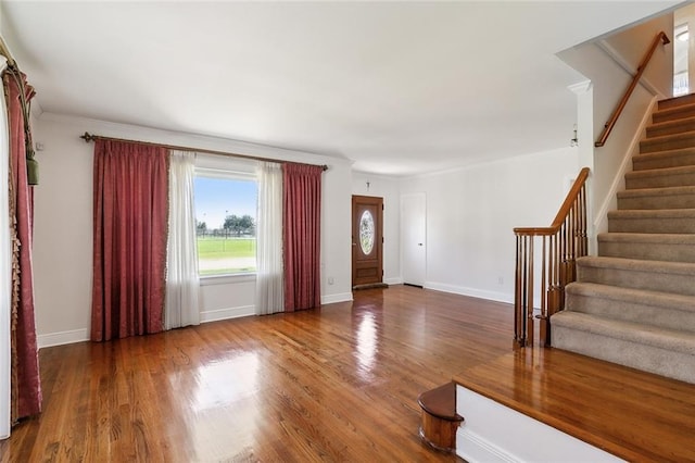 entrance foyer with wood-type flooring and crown molding