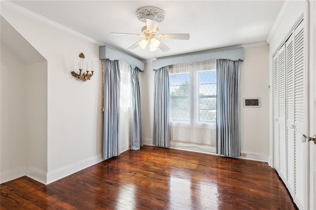 unfurnished bedroom featuring a closet, ceiling fan, crown molding, and dark hardwood / wood-style flooring