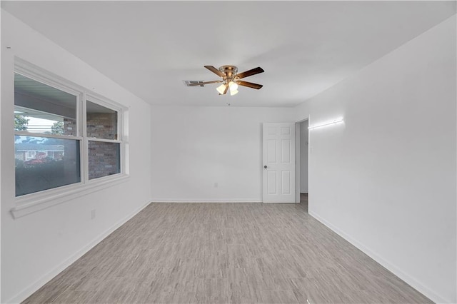 empty room featuring ceiling fan and light hardwood / wood-style flooring