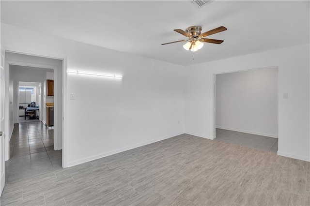 unfurnished room with ceiling fan