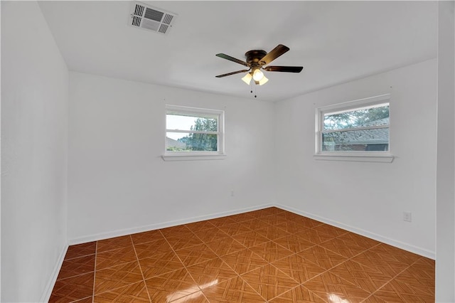 spare room featuring tile patterned flooring and ceiling fan