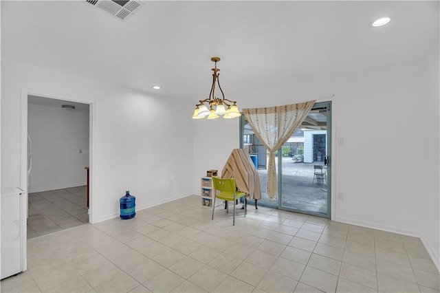 unfurnished dining area with light tile patterned flooring and an inviting chandelier