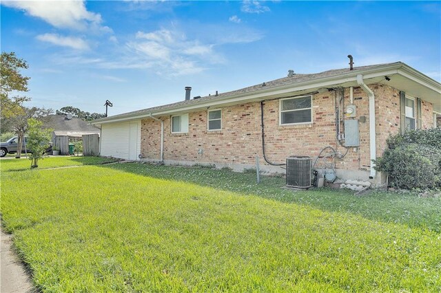 3244 Iowa Ave, Kenner, LA 70065 - view of side of home featuring brick siding, a yard, and cooling unit