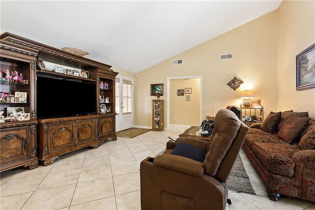 living room with light tile patterned flooring and vaulted ceiling