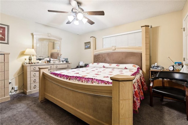 bedroom with dark colored carpet and ceiling fan