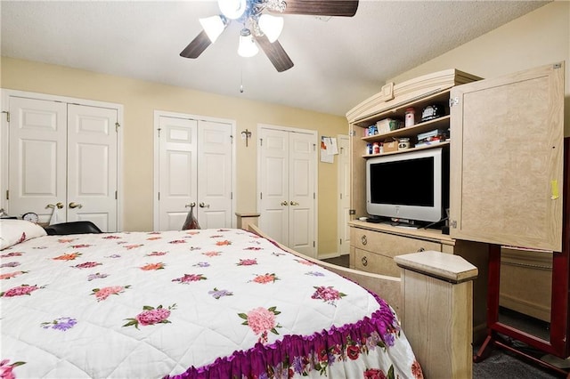 bedroom featuring ceiling fan and multiple closets