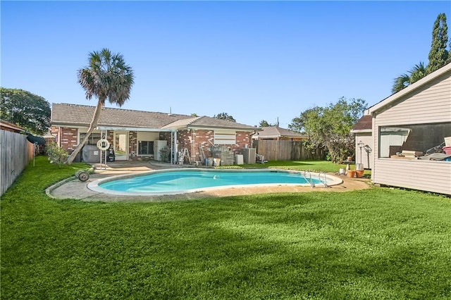 view of swimming pool featuring a yard and a patio area