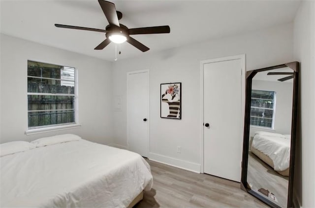 bedroom with light wood-type flooring and ceiling fan