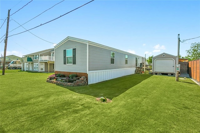 view of home's exterior with a lawn and a shed