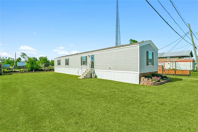 rear view of property featuring a yard