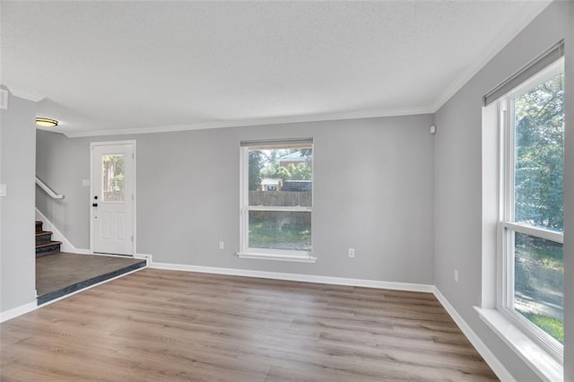3730 Huntlee Dr, New Orleans, LA 70131 - entrance foyer featuring crown molding, healthy amount of natural light, wood finished floors, stairs, and baseboards