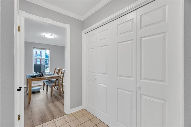 hall with light wood-type flooring and crown molding