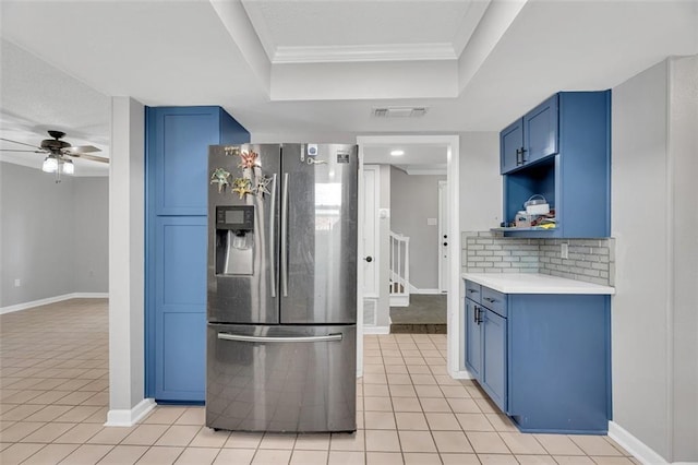 3730 Huntlee Dr, New Orleans, LA 70131 - kitchen featuring stainless steel refrigerator with ice dispenser, blue cabinets, ceiling fan, a tray ceiling, and light tile patterned floors