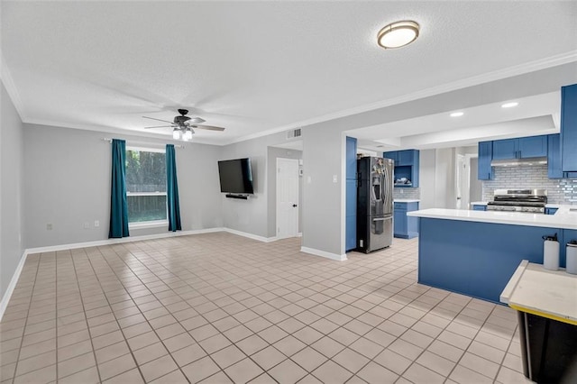 kitchen with ceiling fan, stainless steel appliances, blue cabinets, and ornamental molding