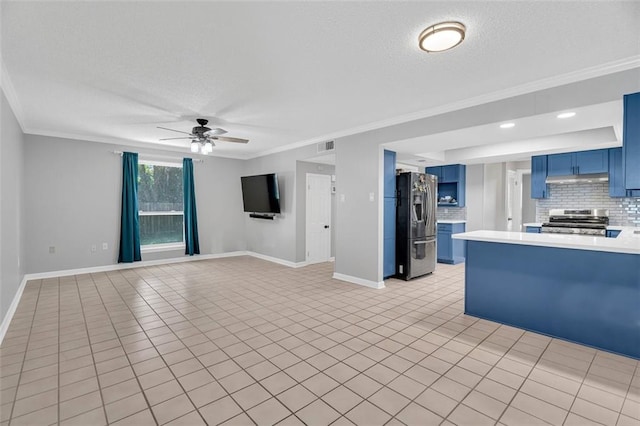 kitchen with blue cabinets, ceiling fan, ornamental molding, backsplash, and appliances with stainless steel finishes