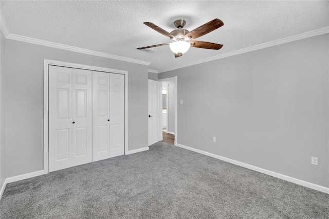 unfurnished bedroom with ceiling fan, carpet floors, and a textured ceiling