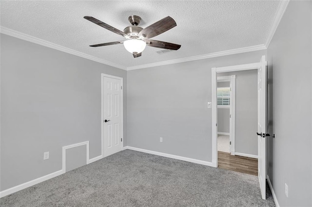 unfurnished room with ornamental molding, a textured ceiling, carpet floors, and ceiling fan