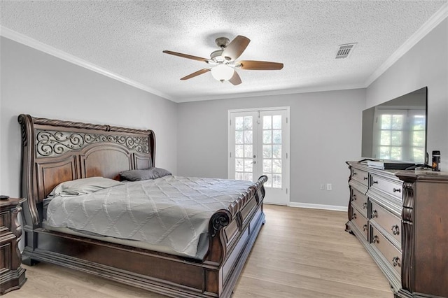 bedroom with a textured ceiling, ornamental molding, ceiling fan, and light hardwood / wood-style flooring