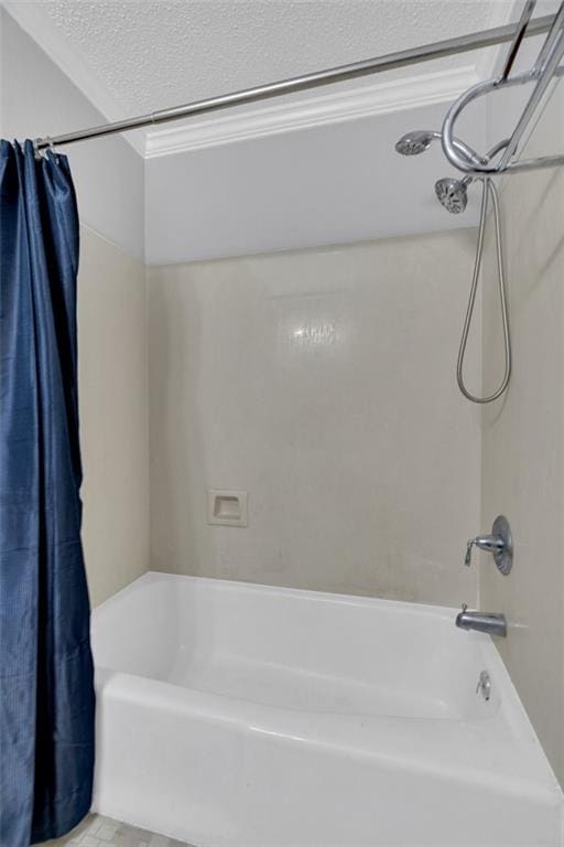 bathroom featuring a textured ceiling and shower / tub combo