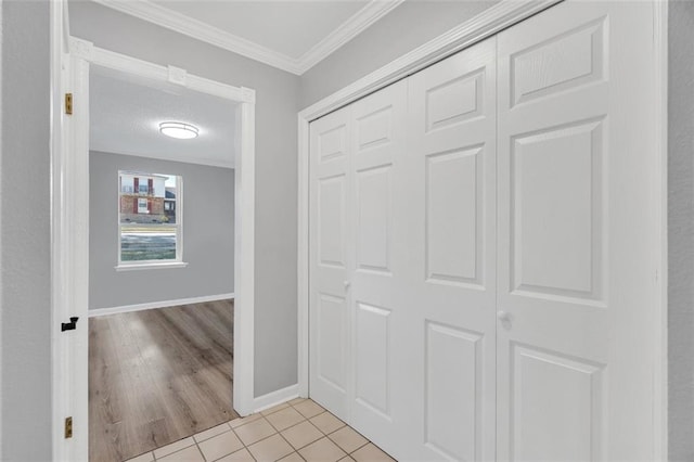 corridor featuring light hardwood / wood-style floors and crown molding