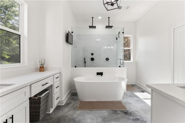 bathroom featuring vanity, separate shower and tub, and concrete floors