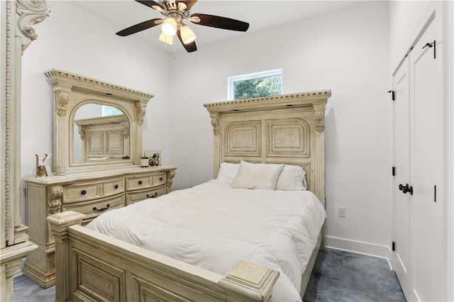 bedroom with dark colored carpet and ceiling fan