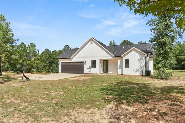 modern farmhouse style home with central AC, a front lawn, and a garage