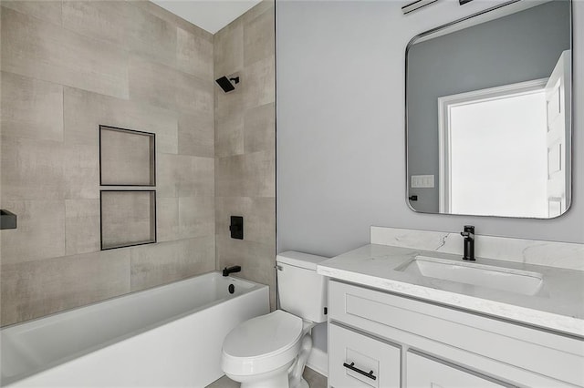 full bathroom featuring vanity, tiled shower / bath combo, and toilet