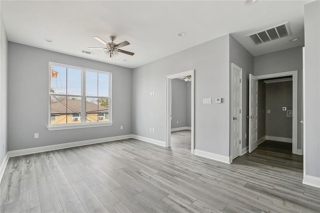 spare room with light hardwood / wood-style floors and ceiling fan